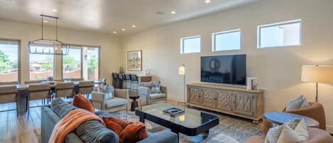 Spacious living room with sofa seating and TV