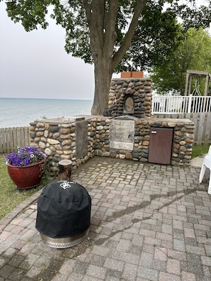 Outdoor kitchen with propane grill cooktop and charcoal grill / pizza oven 