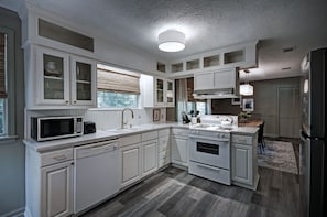 The renovated kitchen with a stove, oven, dishwasher, microwave, refrigerator, kettle, and a Keurig with pods.  Perfect for a corporate stay.