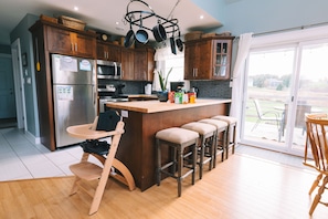 Kitchen area with the island in the foreground.