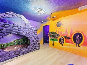 Black Panther Room with custom bunk bed, 43" TV, and murals of Avengers.