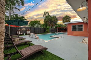 Lounge by the private pool under palms & string lights—paradise at BK Stays!