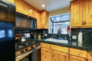 Kitchen fully stocked with all pots, pans, utensils, baking dishes.
