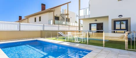 Back of villa with pool and view towards back of property.