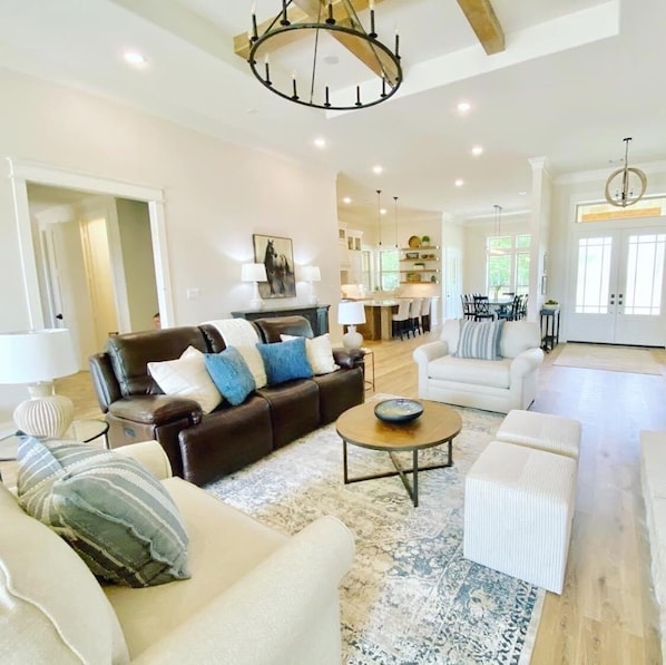 Living room has seating for 9 and flows into kitchen.