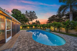 Welcome to Living The Dream! Lined with stunning Eureka Palms, this backyard throws off major tropical vibes.