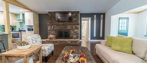 Enjoy this spacious living area where the floor to ceiling fireplace captivates!