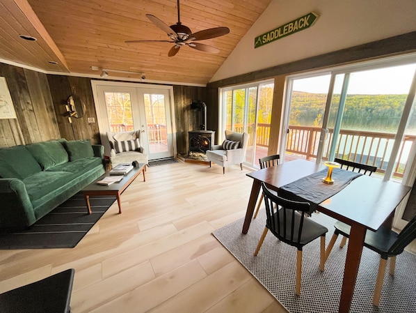 The living room with the fireplace, dining area and queen sleeper sofa.