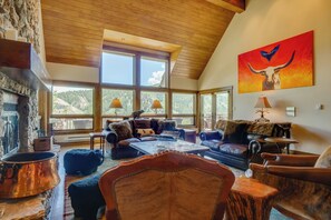 In the main living room, enormous windows allow plenty of natural lighting.