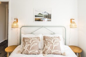 Oh so cozy queen bed with a desk in this room.  Closet with hangers and hanging storage.