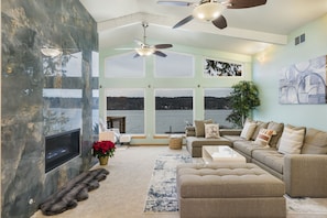 The gorgeous living room with high vaulted ceilings and walls of windows