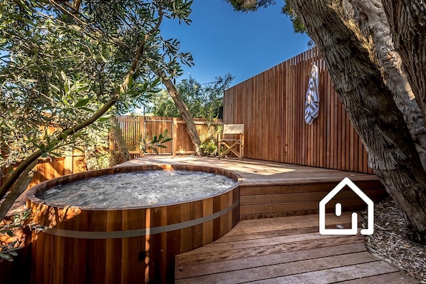 Experience the therapeutic benefits and divine scent of a cedar hot tub