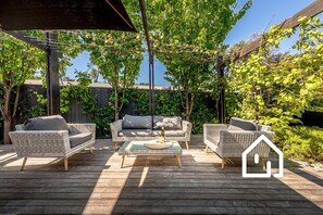 The comfiest outdoor lounge area with plenty of shade offered by two umbrellas