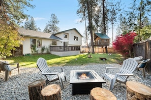 Backyard features bbq, 2 patios, treehouse, and wood fire pit for s'more making fun!