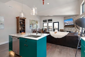 Sparkling clean kitchen sink in a spacious, well-lit cooking area.