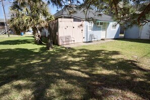 Back of home and outdoor shower and bathroom