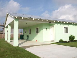 view of driveway and covered parking area