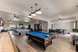 Entertainment room with pool table and lounge.