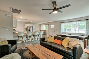 Spacious Open-Concept Living Room for Groups: Relax in this stylish living area with a large sectional, mid-century modern accents, and open flow into the dining and kitchen spaces—perfect for families or friends traveling together.