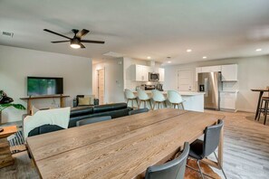 Bright Dining Area with Space for Everyone: Gather around the sleek dining table with modern chairs, perfect for sharing meals or game nights during your stay.