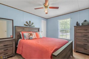 Master with queen bed, two chest of drawers, closet space & ceiling fan.