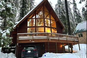 Iconic A-frame cabin with soaring glass and wraparound deck.