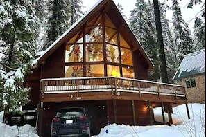 Iconic A-frame cabin with soaring glass and wraparound deck.