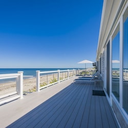Back deck over looking a long stretch of beach for guest access.
