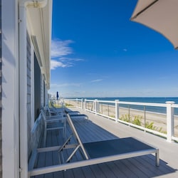 Back deck with ocean views, beach lounge chairs and an umbrella.