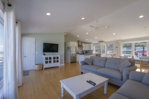 Livingroom with flat screen tv, couches to fit the family and open concept.