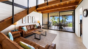 Living area has large windows and siding glass door to enjoy the ocean view