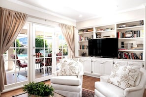 Amazing living room with books, tv, games and as you can see amazing views of the pool, patio and Camelback mountains!!