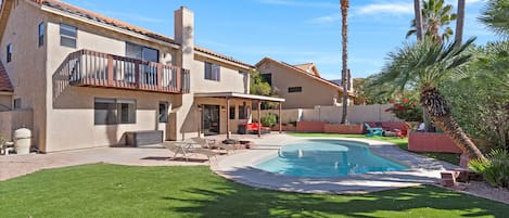 Backyard: Sparkling clean pool is surrounded by desert plants