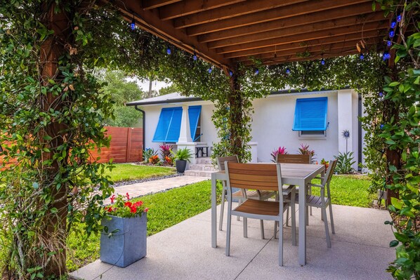 Eat dinner al fresco in the Florida sunshine under our jasmine covered pergola