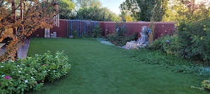  Ornate yard with water feature and artificial turf.