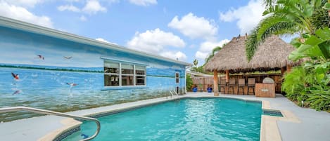 Heated pool is a good size, with Tiki hut Bar/dining area