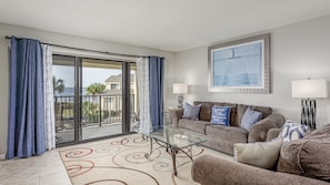 The spacious living room offers a delightful view of the boats on the bay.