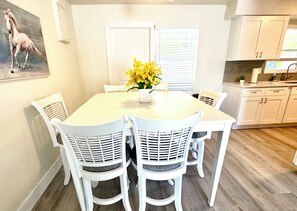 Dining Room with large square table and 6 formal chairs