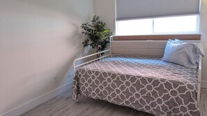 Full size bed with power outlet for your tablet or phone and a twin size bed trundle under that slides out.
