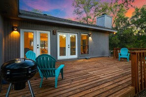 Back deck looks out to dusk with patio furniture.