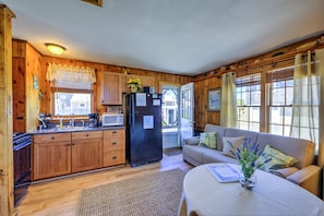 Open concept living with sleeper sofa /dining/kitchen area.