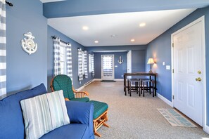 Entry way into open concept living room with sectional for family gatherings.