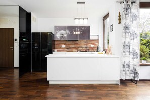 Kitchenette with plenty of kitchen utensils and dishes. 