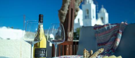 The terrace is the ideal place to enjoy a bottle of the unique Santorini wine.