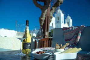 The terrace is the ideal place to enjoy a bottle of the unique Santorini wine.