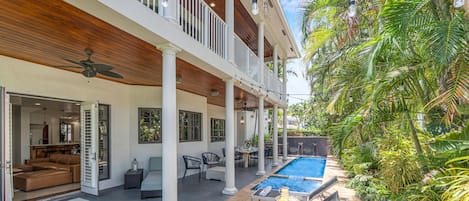 Quintessential Florida Keys style villa updated with modern fixtures, quaint breezy verandas, and towering ceilings. Unwind in the heated pool nestled in a tropical garden.