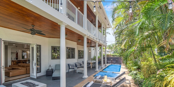 Quintessential Florida Keys style villa updated with modern fixtures, quaint breezy verandas, and towering ceilings. Unwind in the heated pool nestled in a tropical garden.