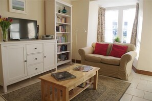 Lounge with open fire at Barton Cottage in West Burton, Wensleydale in the Yorkshire Dales