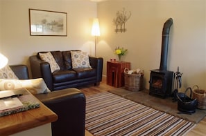 Lounge with cosy woodburning stove at Hill Top Cottage in Walden dale near West Burton in the Yorkshire Dales