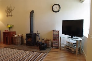 Lounge with cosy woodburning stove at Hill Top Cottage in Walden dale near West Burton in the Yorkshire Dales